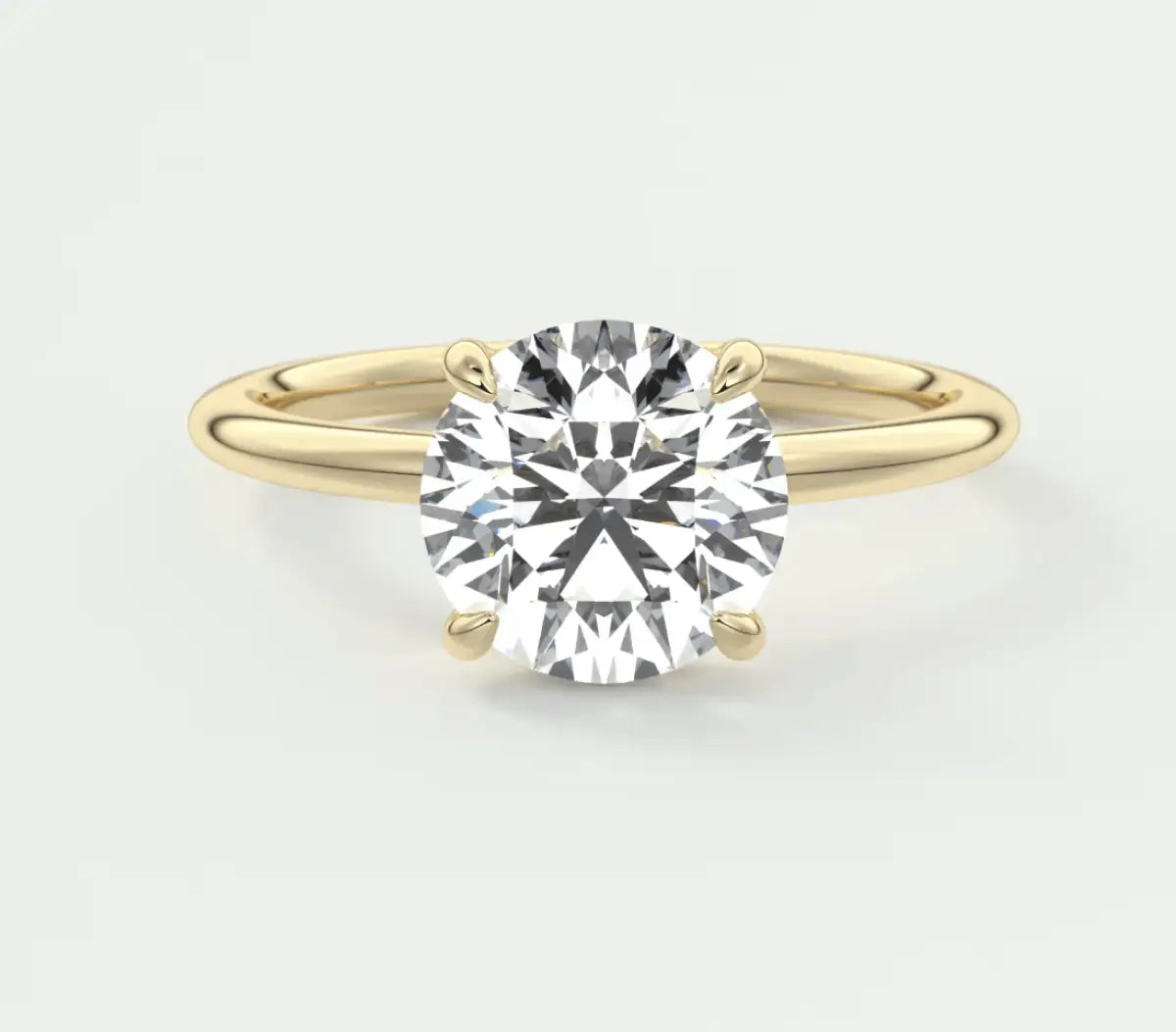 18k yellow gold solitaire diamond engagement ring with a round brilliant cut stone.