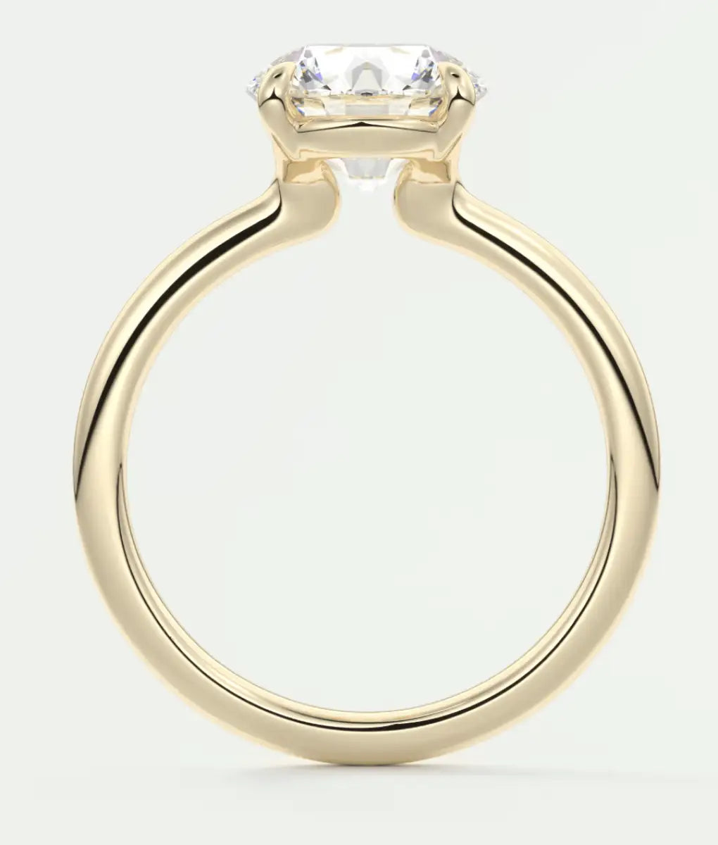 18k yellow gold engagement ring with a cushion-cut diamond.