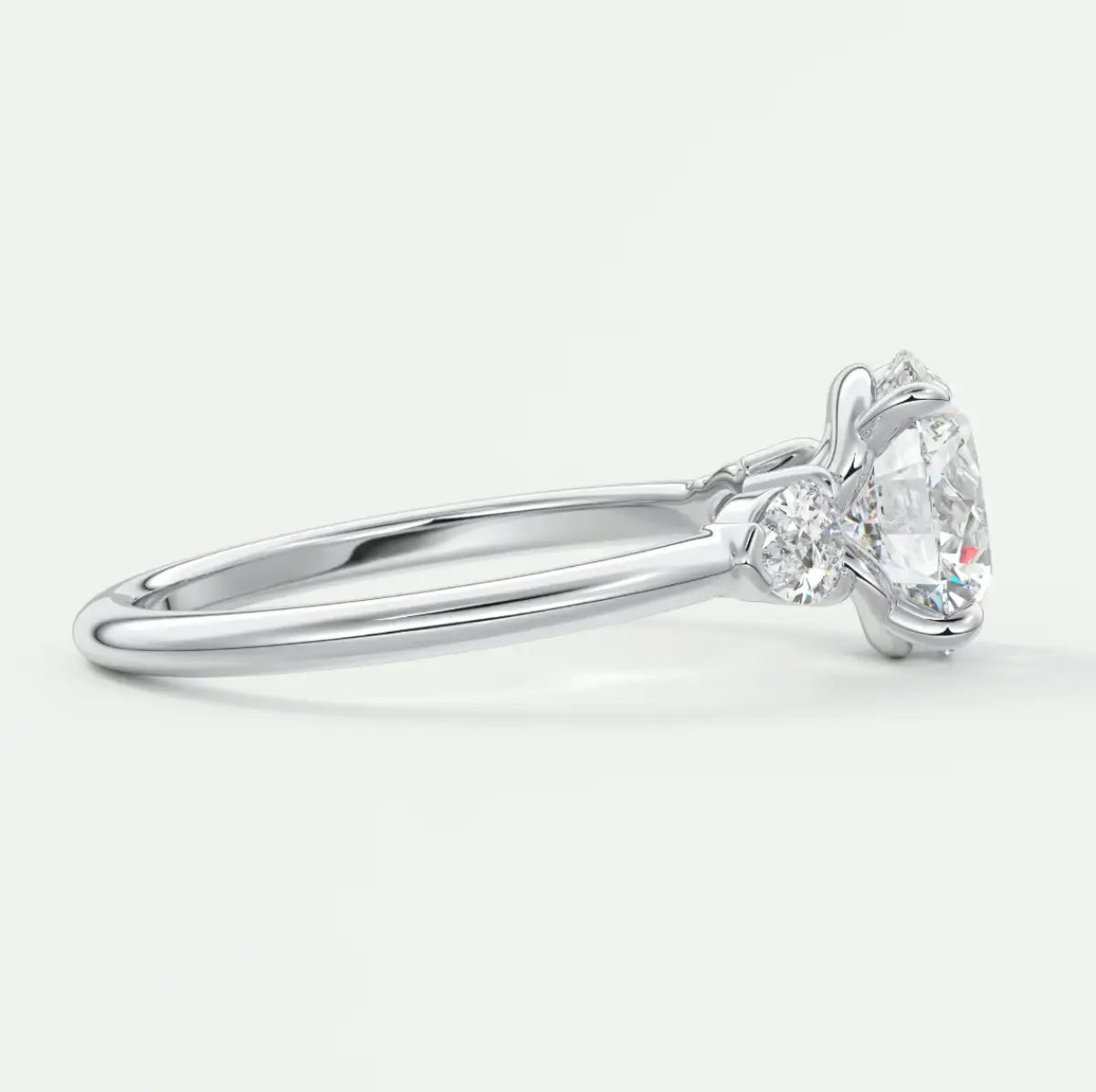 Custom made elysian round three-stone engagement ring with pear side stones | diamond lab