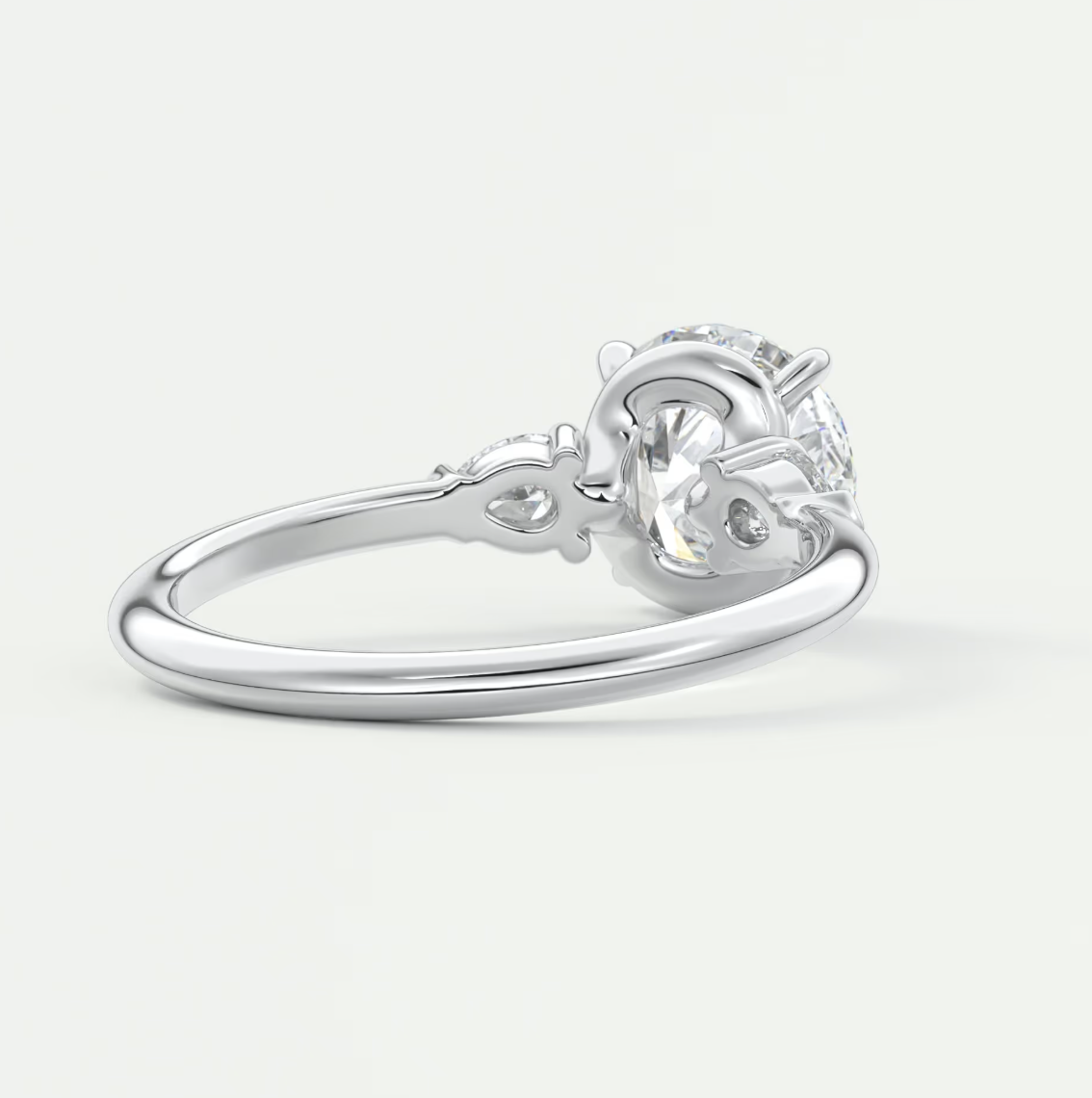 Custom made elysian round three-stone engagement ring with pear side stones | diamond lab