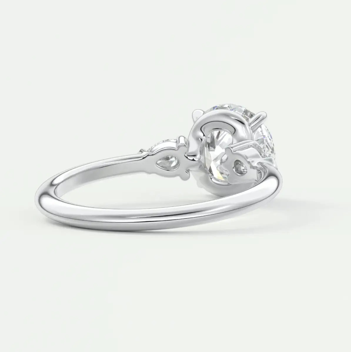 Custom made elysian round three-stone engagement ring with pear side stones | diamond lab