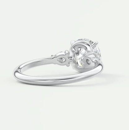 Custom made elysian round three-stone engagement ring with pear side stones | diamond lab