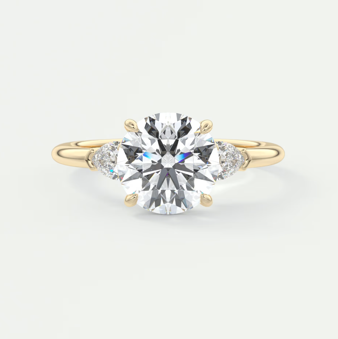 Custom made elysian round three-stone engagement ring with pear side stones | diamond lab