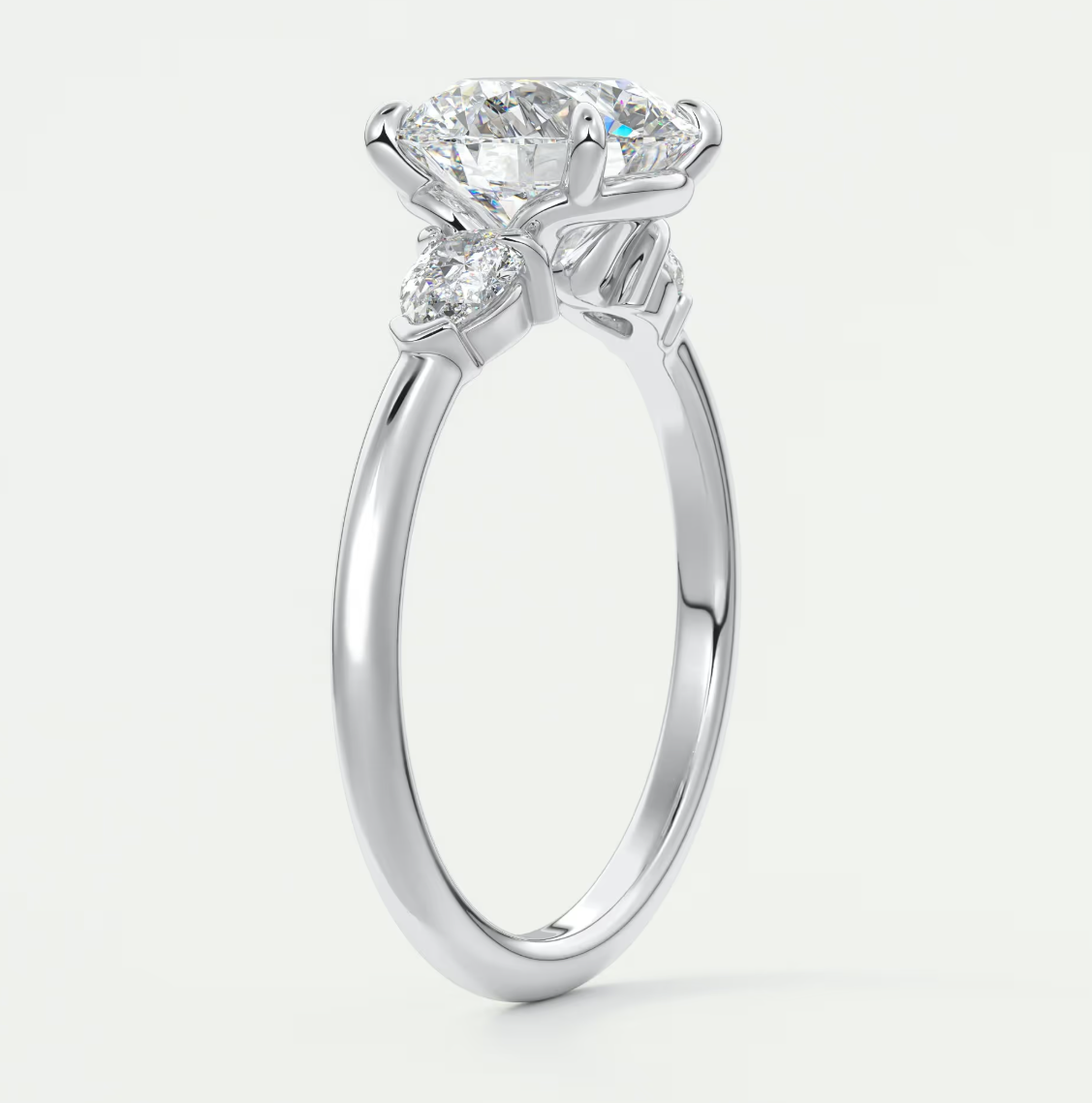Custom made elysian round three-stone engagement ring with pear side stones | diamond lab