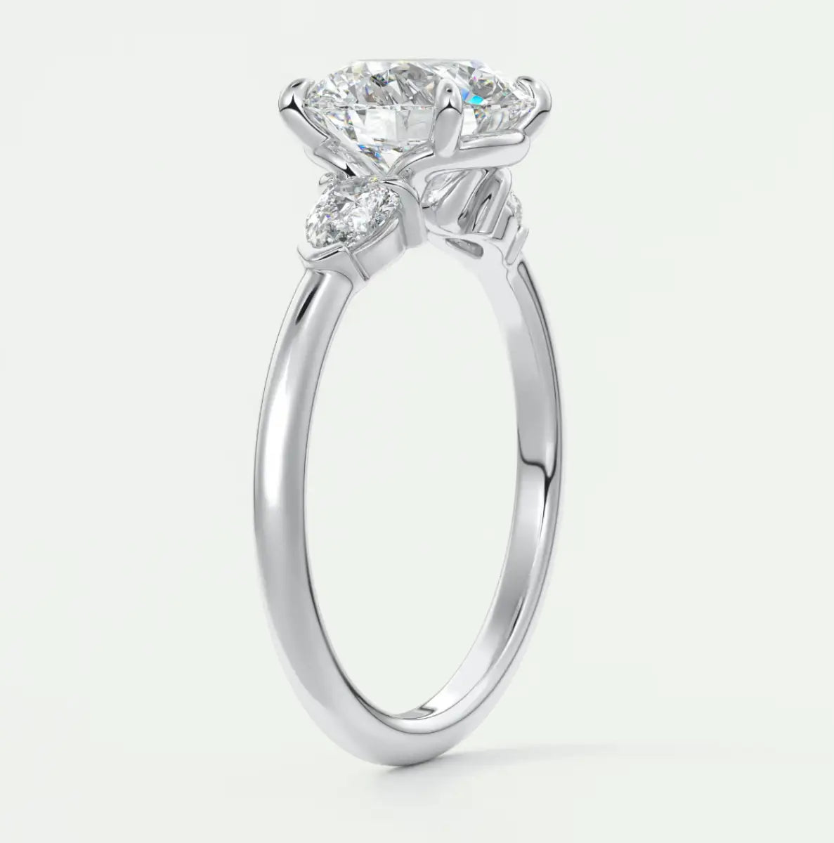 Custom made elysian round three-stone engagement ring with pear side stones | diamond lab