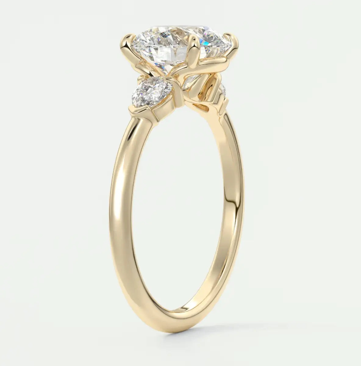 Custom made elysian round three-stone engagement ring with pear side stones | diamond lab