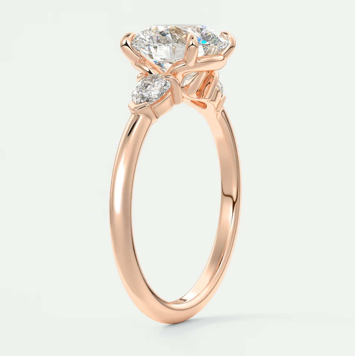 Custom made elysian round three-stone engagement ring with pear side stones | diamond lab