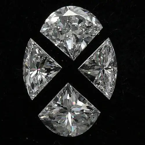 Four brilliant-cut diamonds arranged in a symmetrical cross pattern, each showcasing intricate facets and sparkling clarity against a dark background.