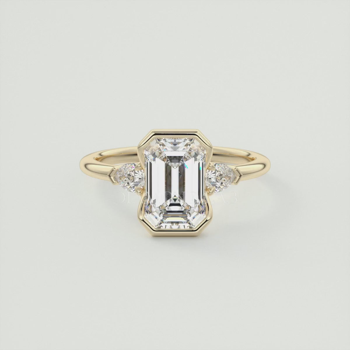 Load video: Solara Emerald Half Bezel Three-Stone Engagement Ring