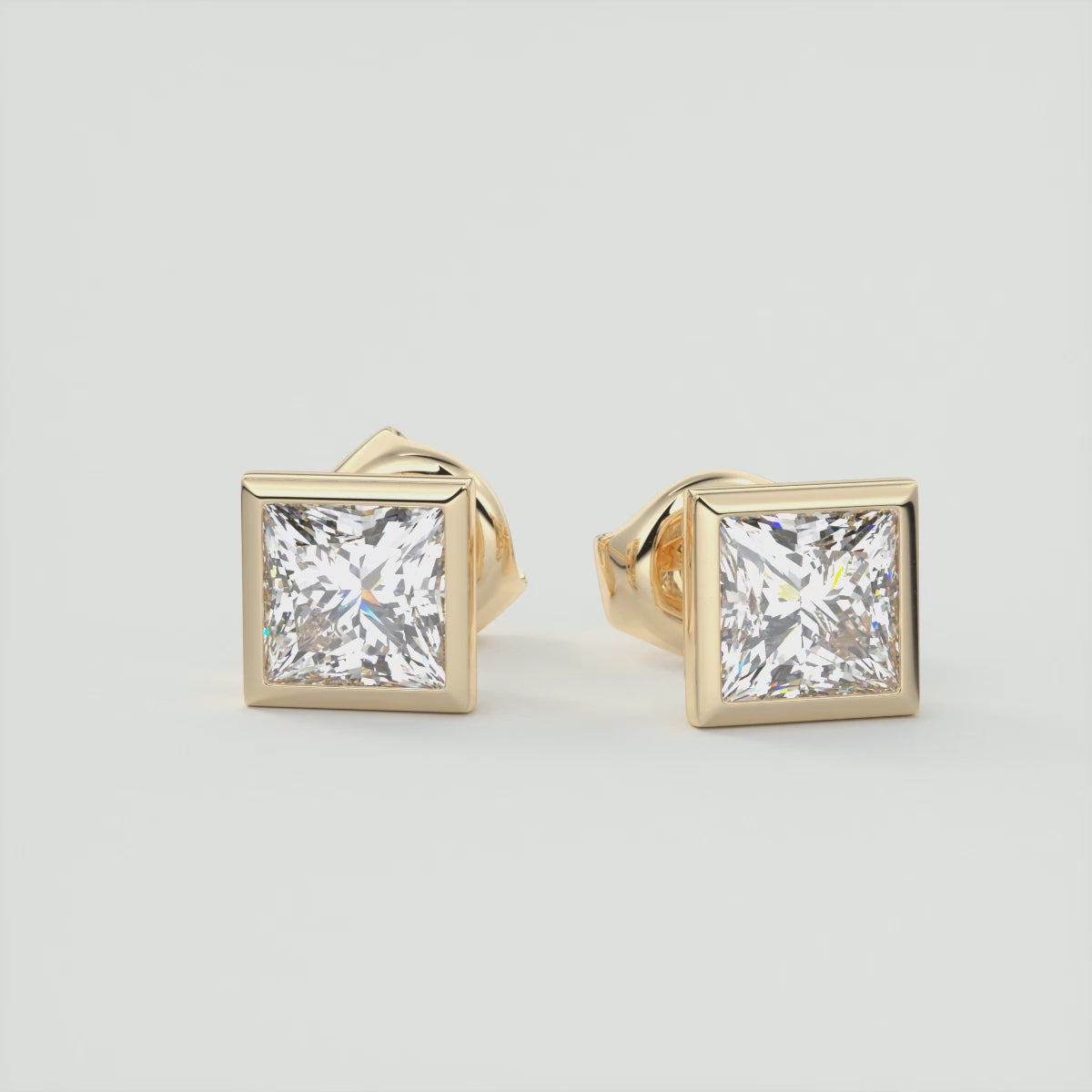 Load video: Radiant Princess Bezel Stud Earrings | Lab Diamond or Moissanite