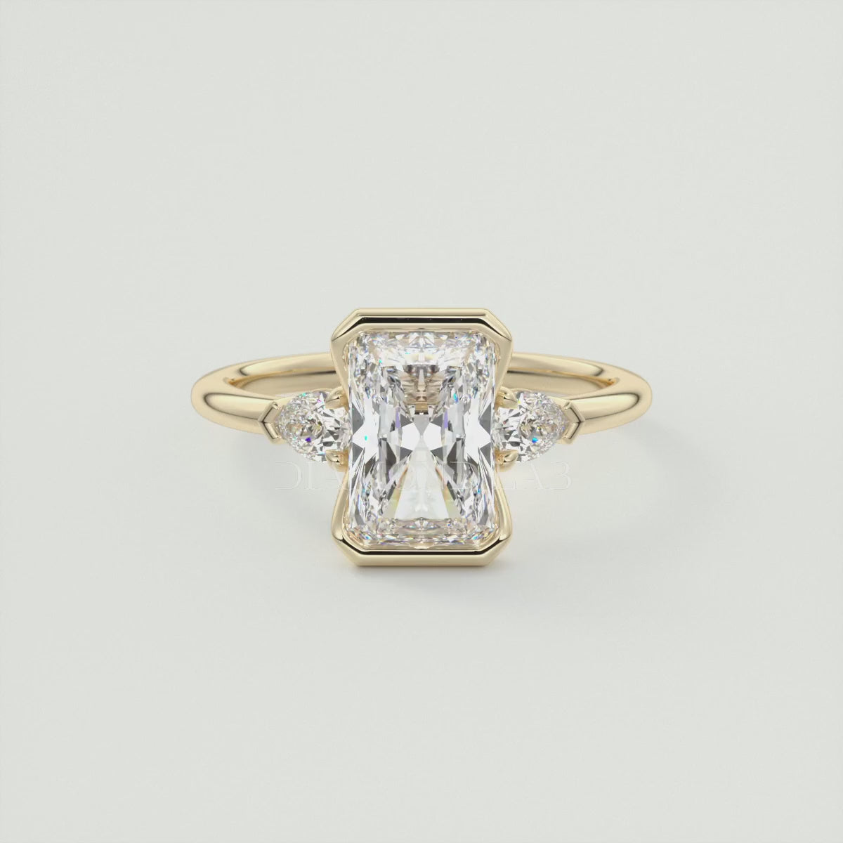 Load video: Solara Elongated Radiant Half Bezel Three-Stone Engagement Ring