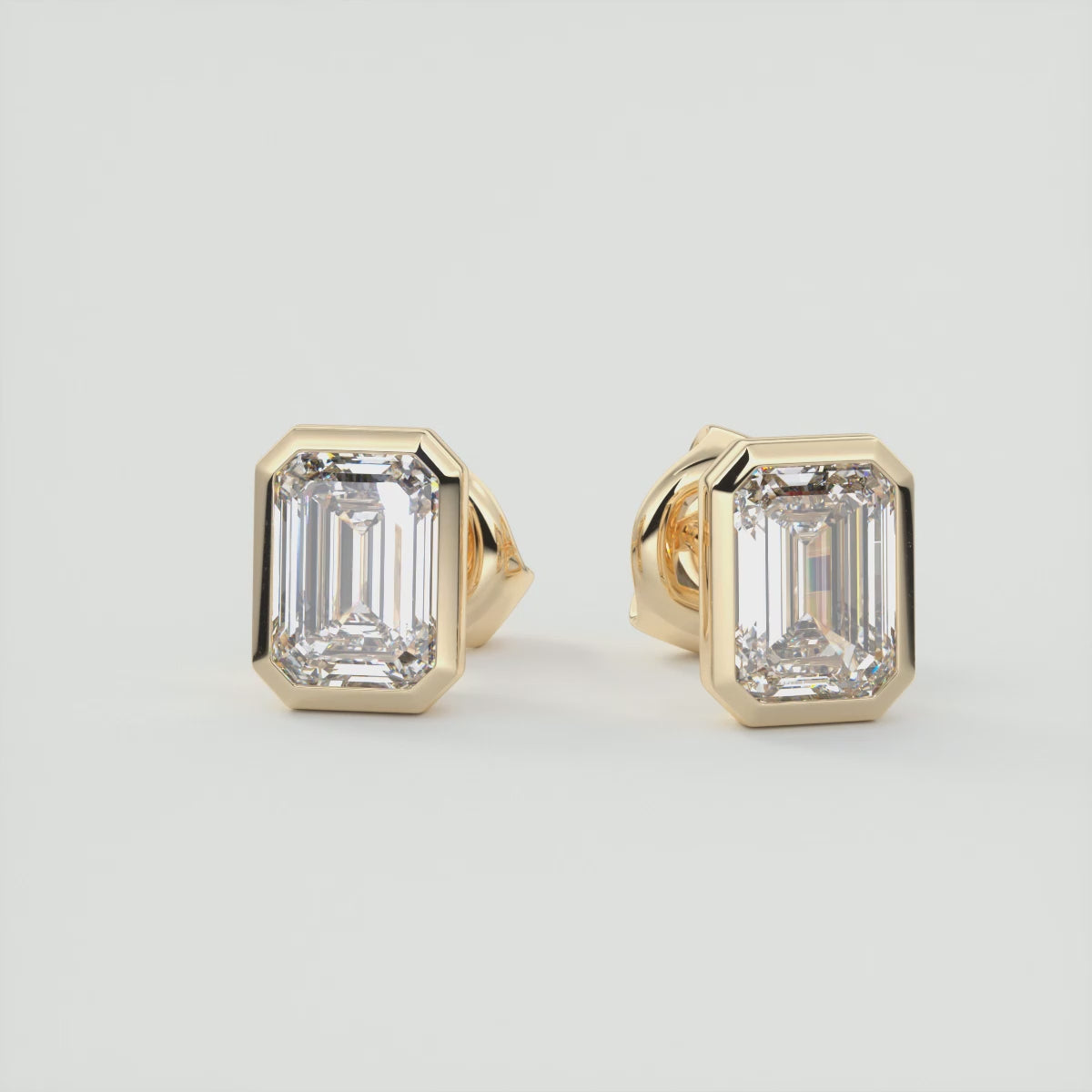 Load video: Sophisticated Emerald Bezel Stud Earrings | Lab Diamond or Moissanite