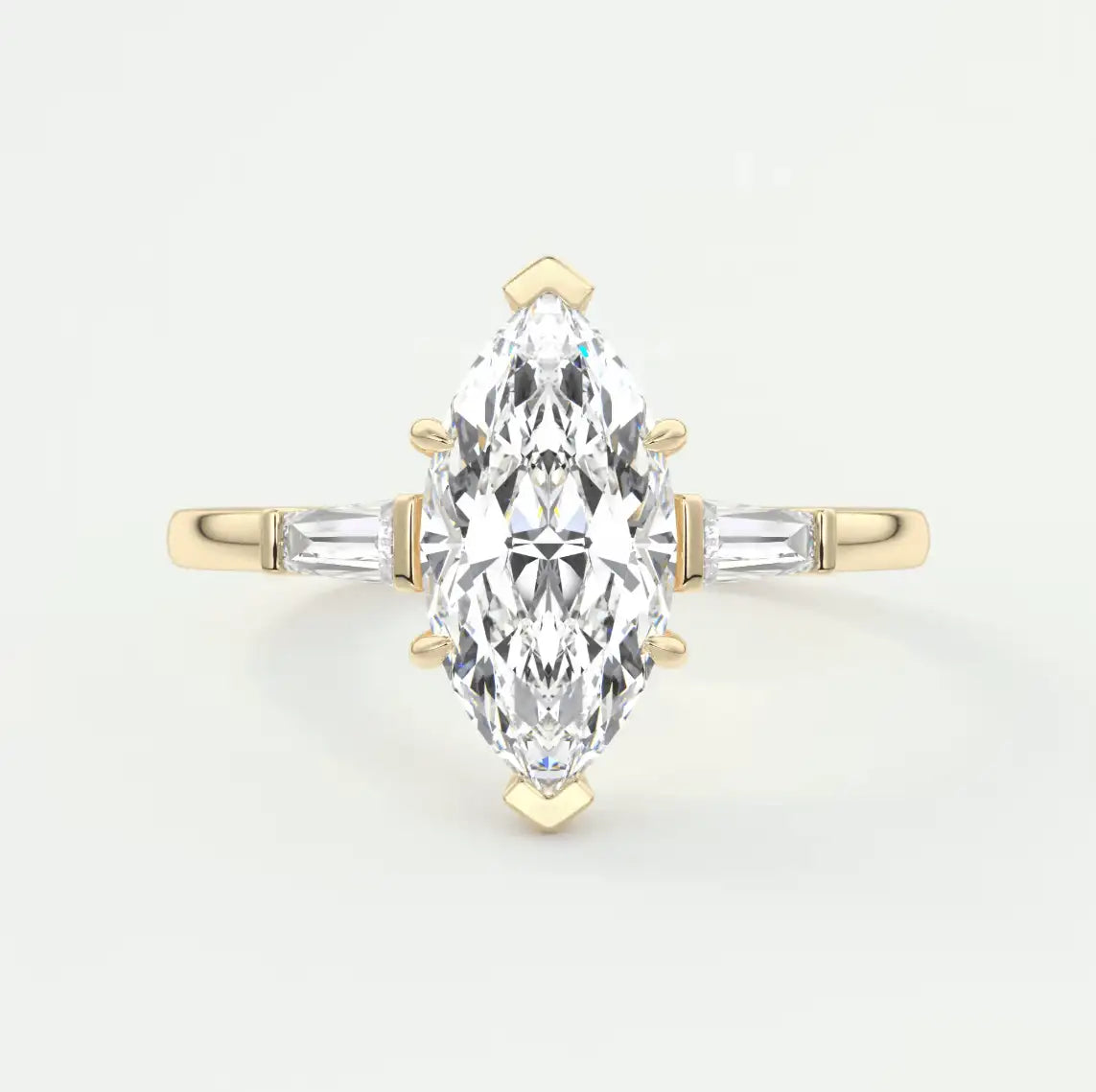 Gold ring with a marquise-shaped diamond on a light gray background