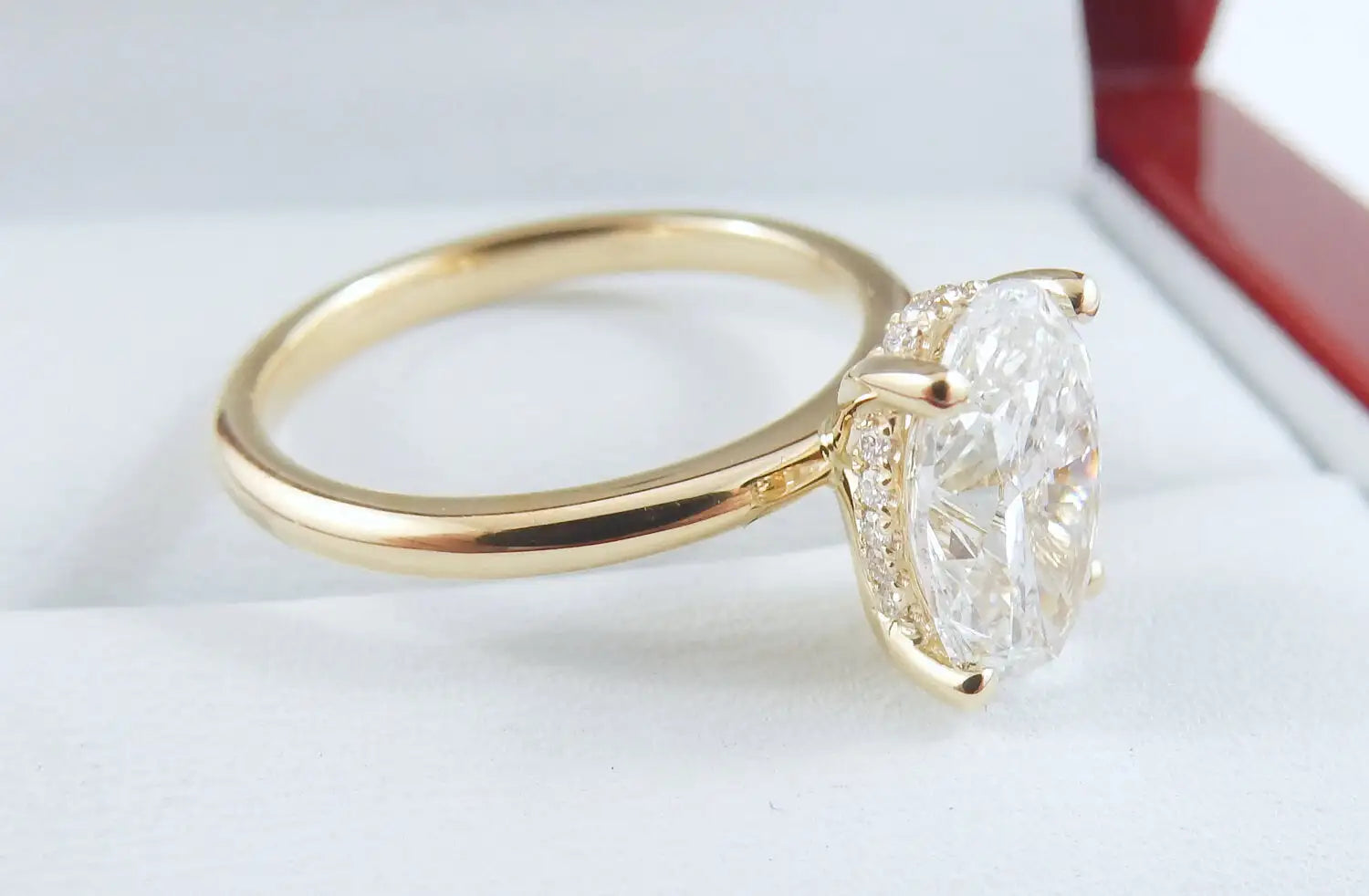 Gold ring with a large diamond on a white background