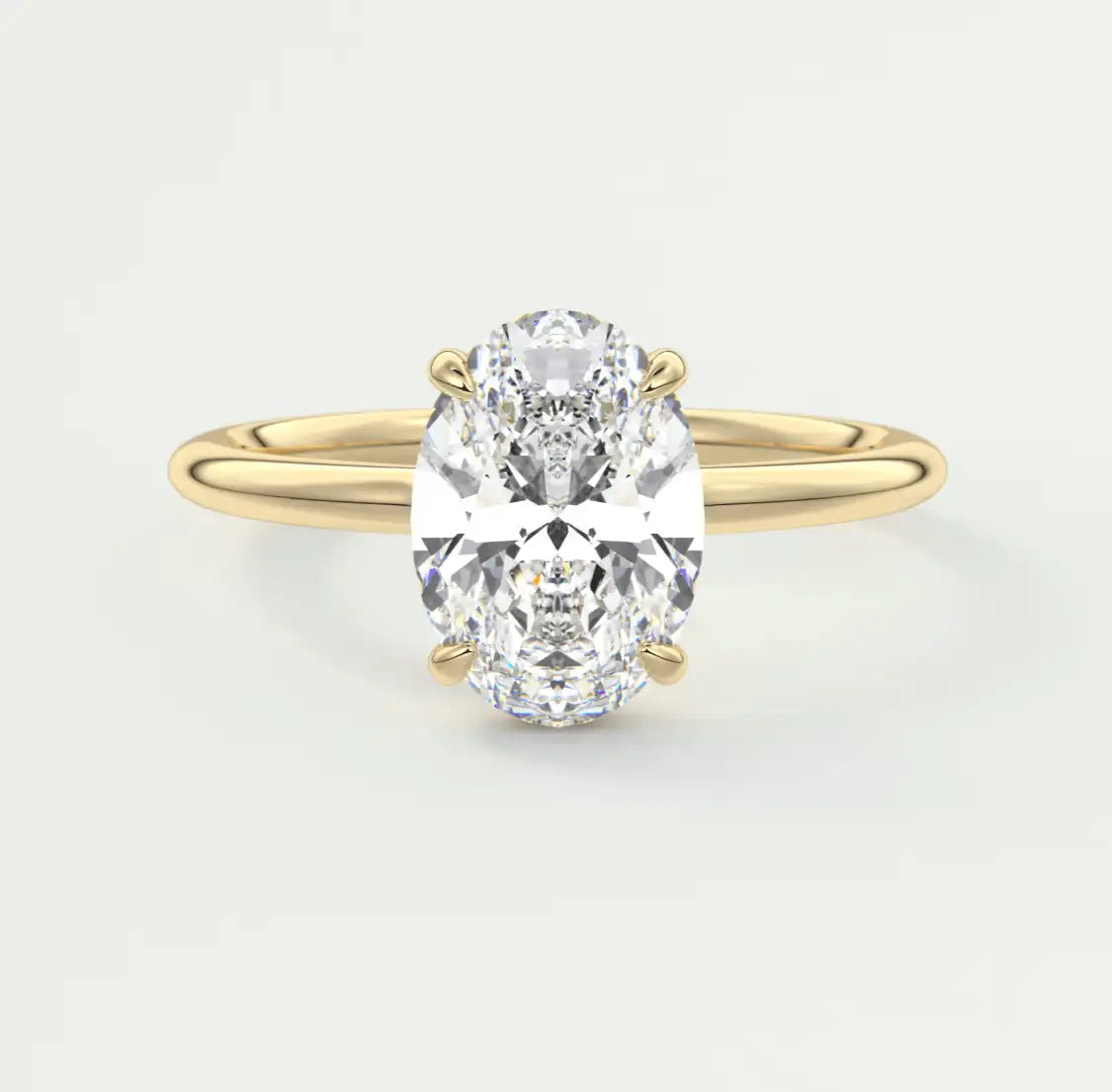 18-karat yellow gold oval diamond engagement ring.