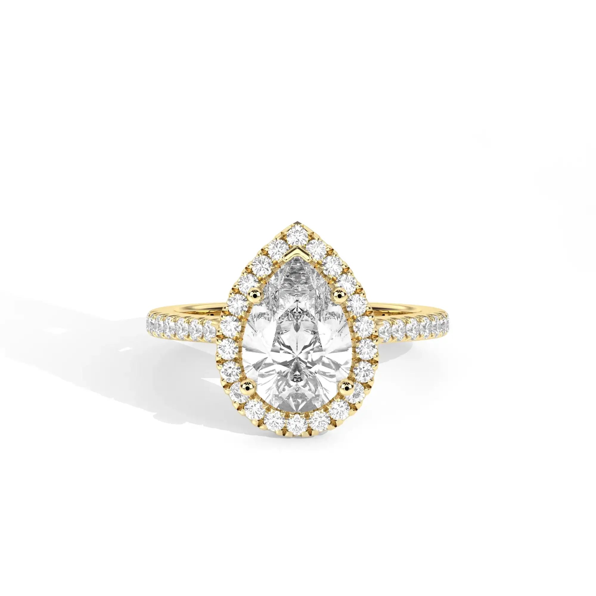 Gold ring with a pear-shaped diamond and smaller diamonds on a white background