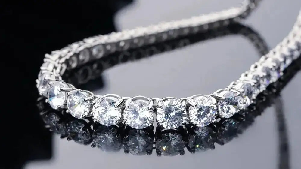 Diamond bracelet on a reflective surface with a dark background