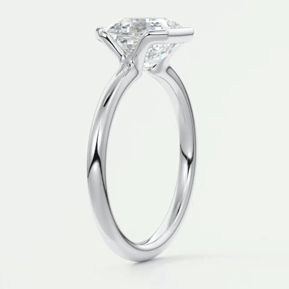 18-karat white gold solitaire engagement ring with a princess-cut diamond.