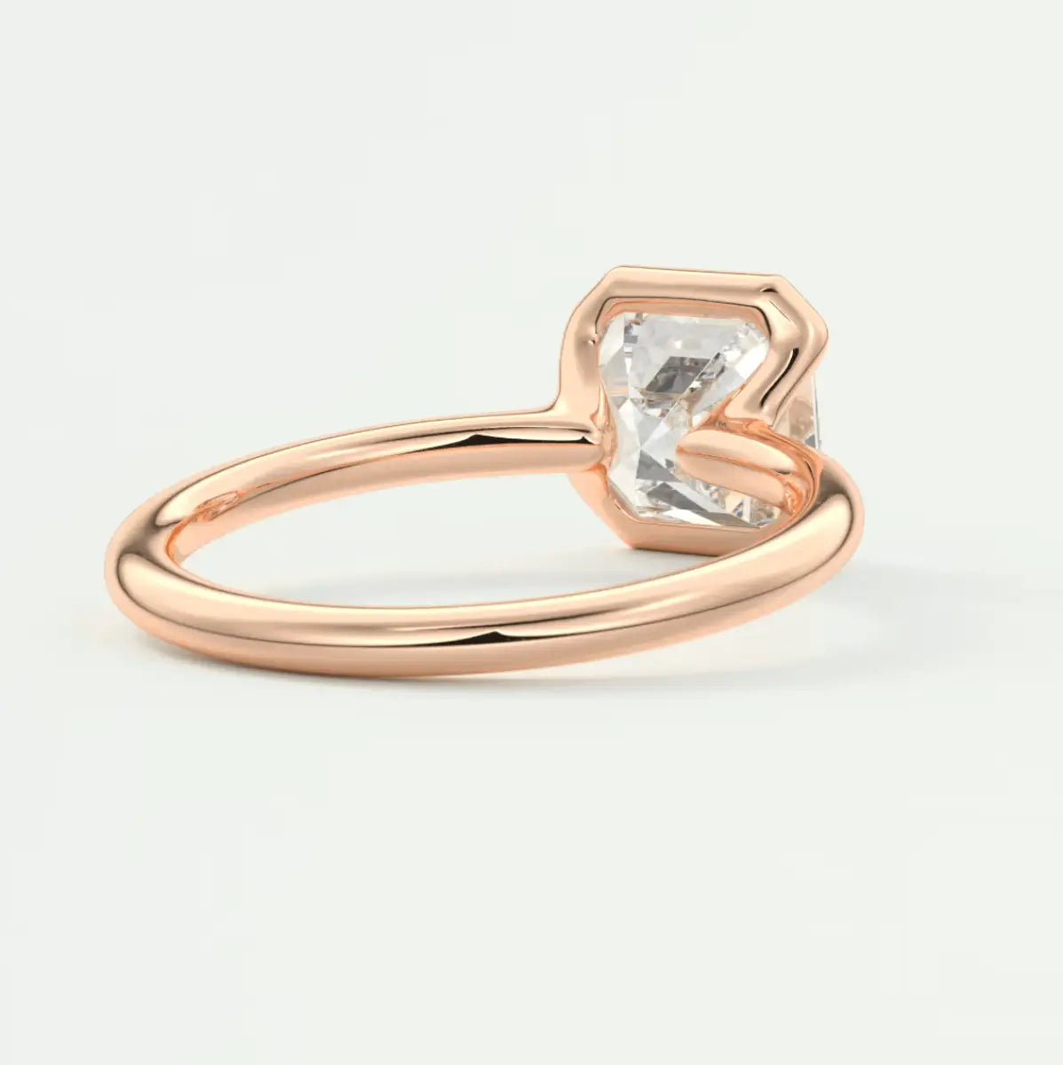 Rose gold engagement ring with a square-cut diamond.
