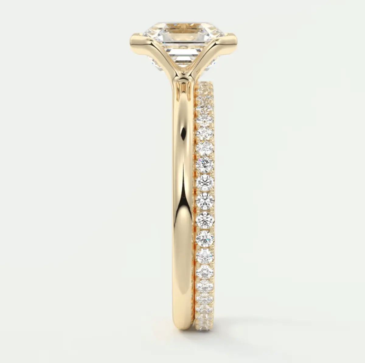 18k yellow gold engagement ring with princess cut diamond and pave set diamonds on the band.