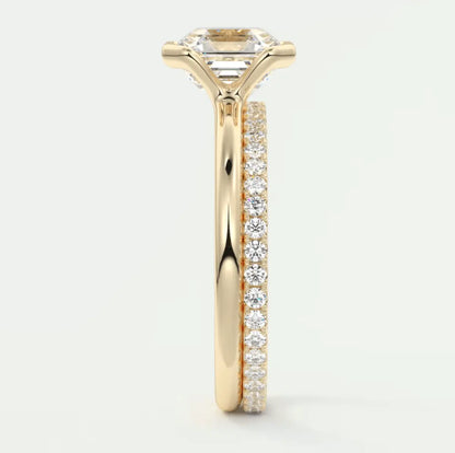 18k yellow gold engagement ring with princess cut diamond and pave set diamonds on the band.