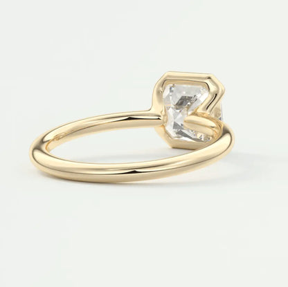 Gold solitaire engagement ring with a princess cut diamond.