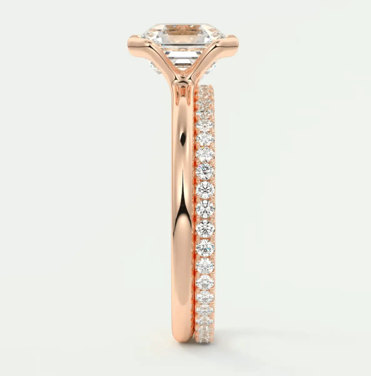 18k rose gold engagement ring with princess cut diamond and pavé side stones.