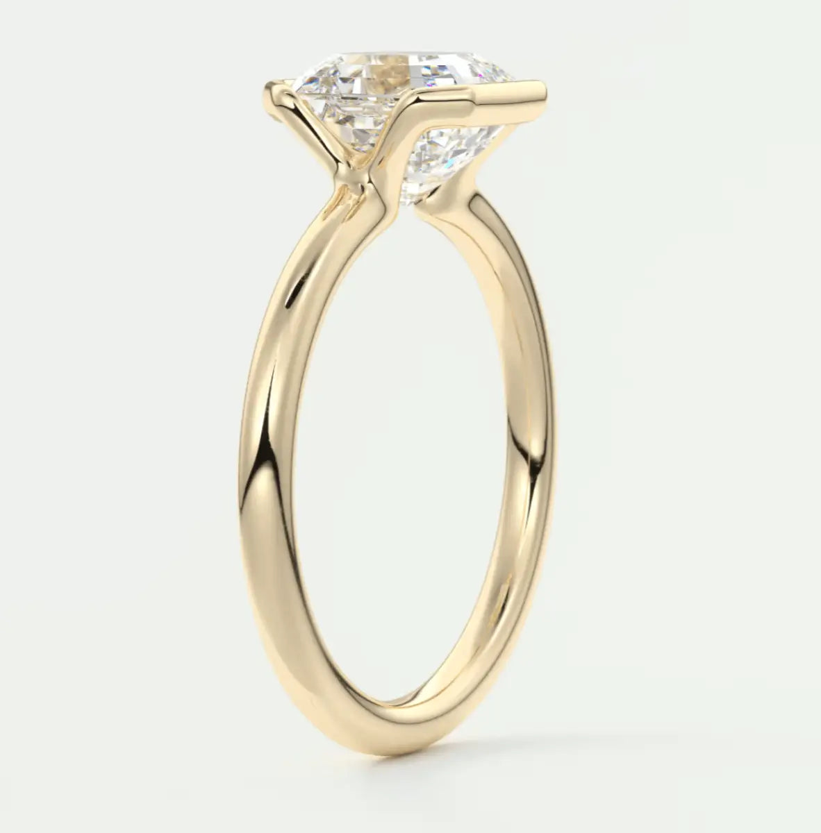 18k yellow gold engagement ring with a princess cut diamond.