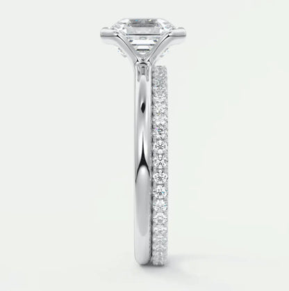 18k white gold diamond engagement ring with a princess cut center stone and pave set diamonds on the band.