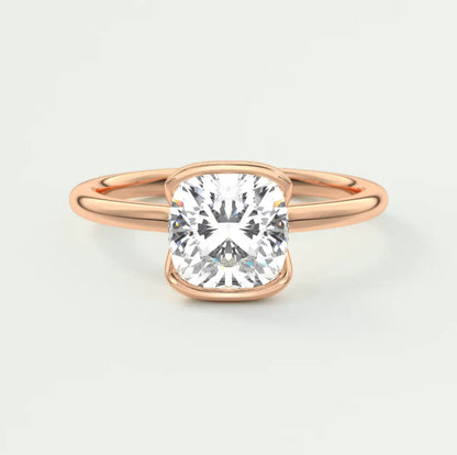 Rose gold cushion-cut diamond engagement ring with a solitaire design.