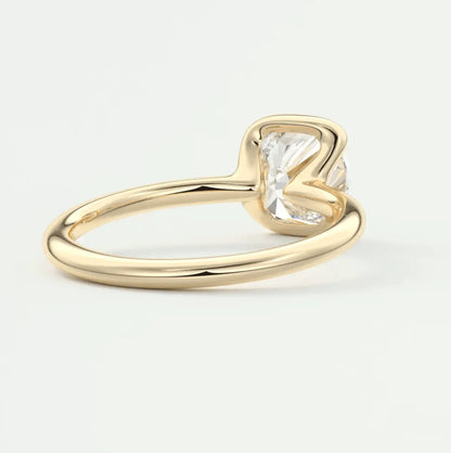 Gold cushion-cut diamond engagement ring with a simple band design.
