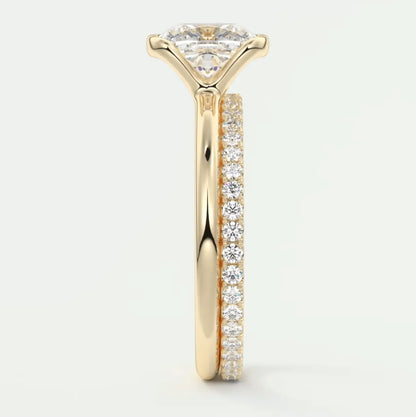 18k yellow gold diamond engagement ring with a princess cut center stone and pave set diamonds on the band.