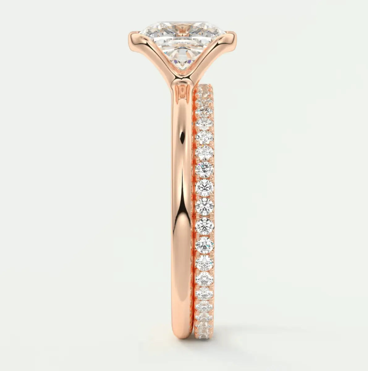 18k rose gold diamond engagement ring with a round brilliant cut center stone and pavé set diamonds on the band.