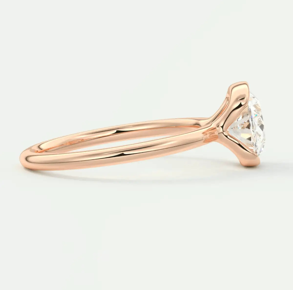 Rose gold diamond engagement ring with a classic solitaire design and cushion-cut gemstone.
