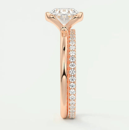 18k rose gold diamond engagement ring with a round brilliant cut center stone and channel set diamonds on the band.