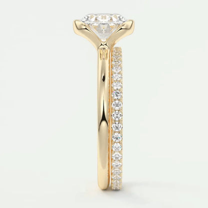 18k yellow gold diamond engagement ring with a round brilliant cut center stone and pave set diamonds on the band.