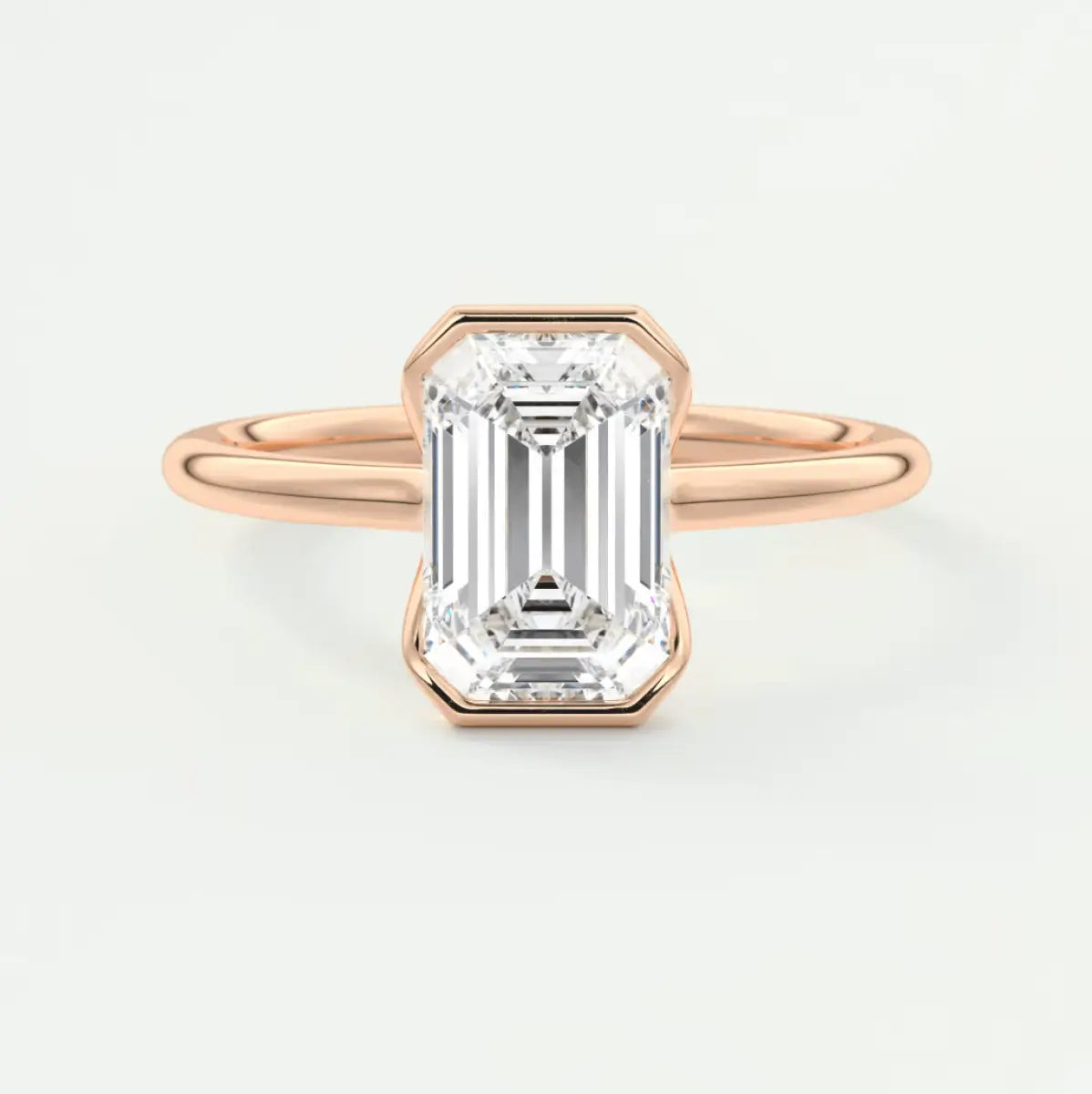 18-karat rose gold emerald-cut diamond engagement ring.