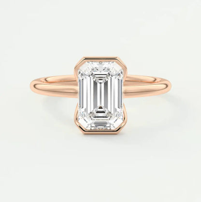 18-karat rose gold emerald-cut diamond engagement ring.