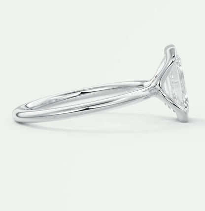 White gold solitaire engagement ring with a marquise-cut diamond.