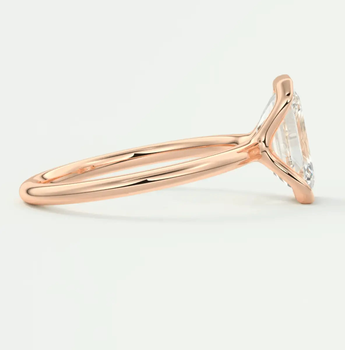 Rose gold marquise cut diamond engagement ring with a classic solitaire design.