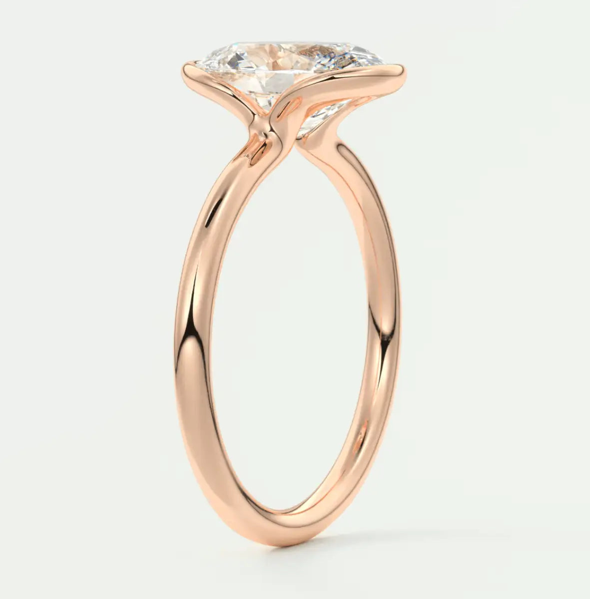 Rose gold engagement ring with a large, round diamond center stone.