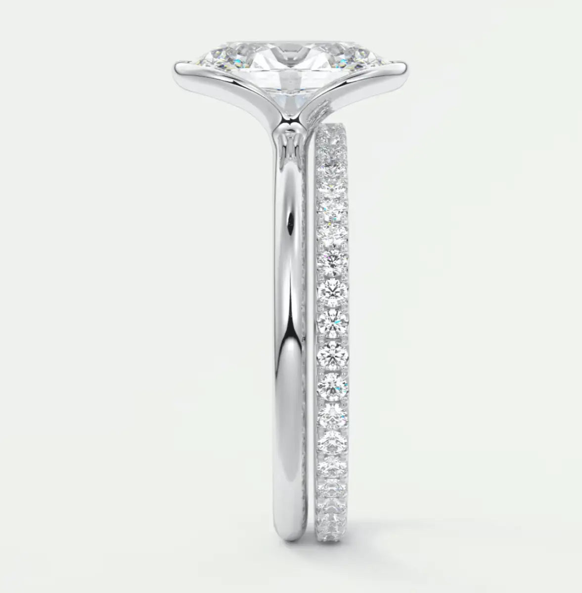 18k white gold diamond engagement ring with a round brilliant cut center stone and pave set diamonds on the band.