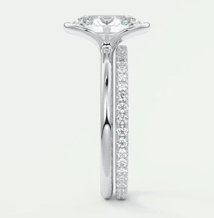 18k white gold diamond engagement ring with a round brilliant cut center stone and pave set diamonds on the band.
