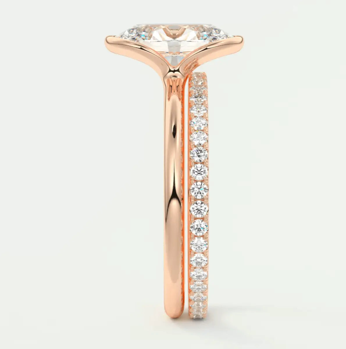 18-karat rose gold engagement ring with a marquise-cut diamond and channel-set diamonds on the band.