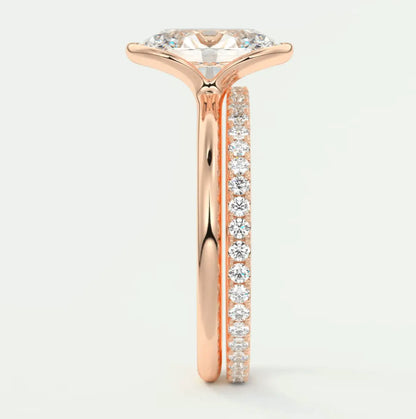 18-karat rose gold engagement ring with a marquise-cut diamond and channel-set diamonds on the band.