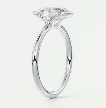 18k white gold solitaire diamond engagement ring with a round brilliant cut stone.
