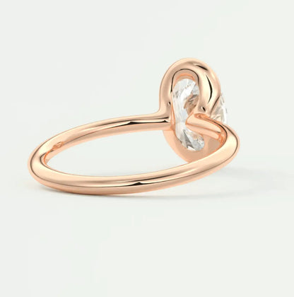 Rose gold heart-shaped diamond engagement ring with a single large stone.