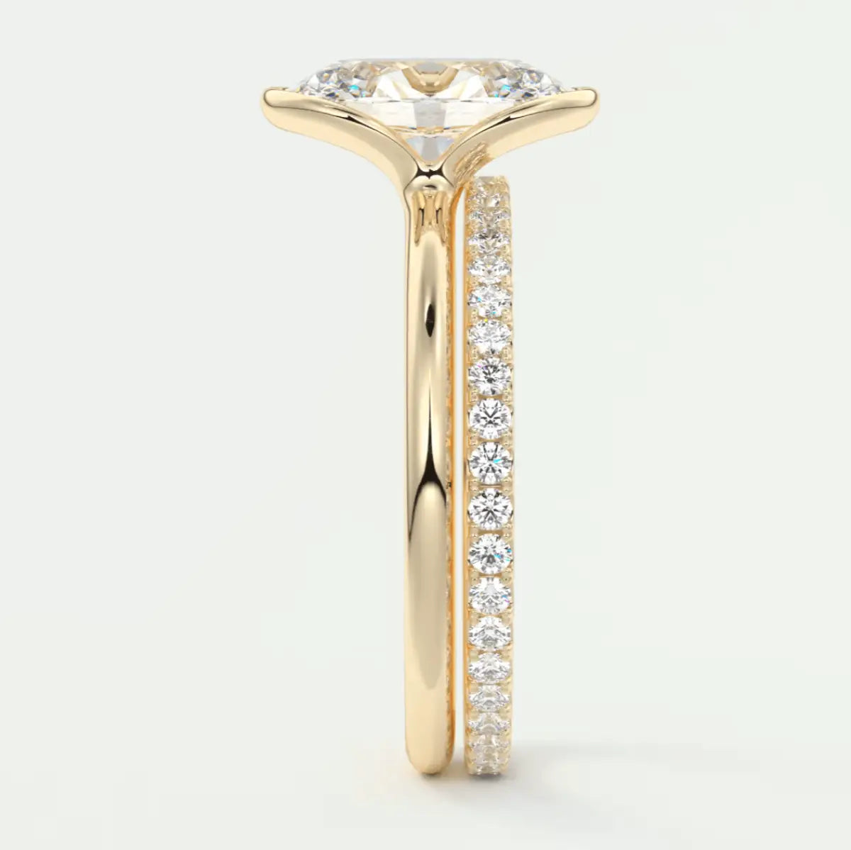 18k yellow gold engagement ring with a marquise-cut diamond and pave set diamonds on the band.