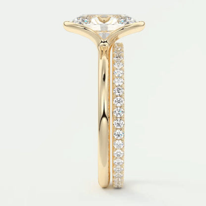 18k yellow gold engagement ring with a marquise-cut diamond and pave set diamonds on the band.