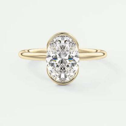 18k yellow gold oval diamond engagement ring with a bezel setting.